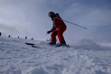 Skiers Going Down a Snowy Slope at Ski Resort in Winter