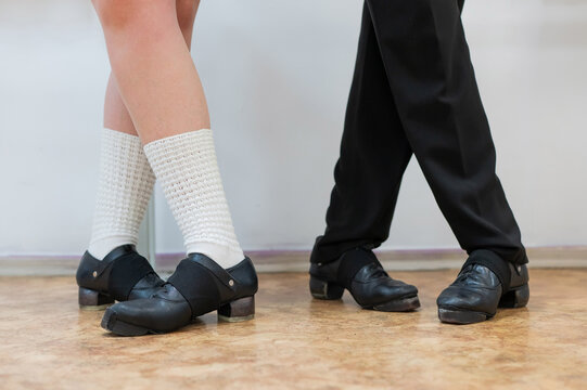 Close-up of female and male legs dancing traditional Irish stepdance. 