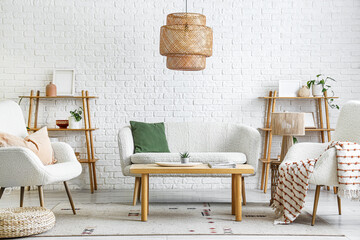 Interior of light living room with sofa, armchairs and plants © Pixel-Shot