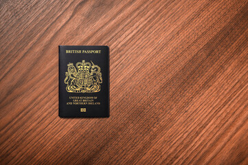 British Passport on the left hand side on Wooden Surface