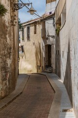 Obraz premium Badalona, Spain - June 19, 2022. View of old street in Dalt la Vila, building with colored facade, historic center of Badalona, province of Barcelona, Spain.