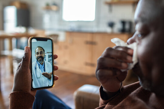 Sick man video calling doctor at home