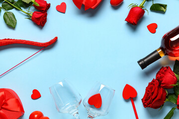 Obraz premium Frame made of cupid's bow, arrow, bottle of wine and rose flowers on blue background. Valentine's Day celebration