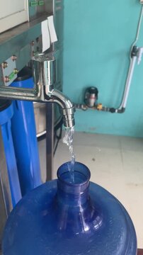Drinking Water Refill Process at Water Purification Station. Water Refill System with Clean Drinking Water Flow