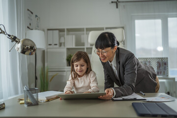 Fototapeta premium Working mother balancing professional career with family life