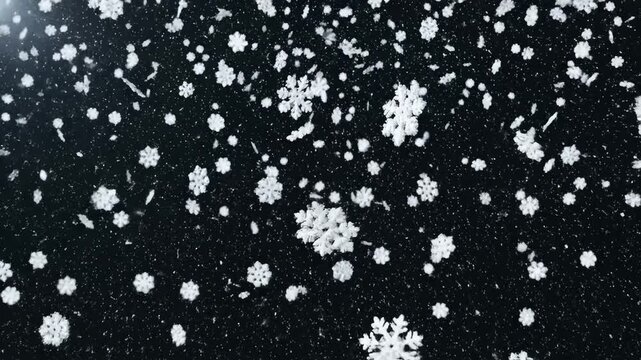 Falling snowflakes against dark background