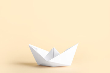 Naklejka premium White paper boat on beige background