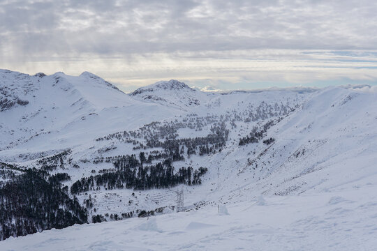 Snowy mountain landscape at Valgrande-Pajares ski resort in northern Spain, close view of snow-covered peaks and panoramic views from the top of the mountain