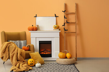 Naklejka premium Interior of living room decorated for Halloween with fireplace, armchair and ladder