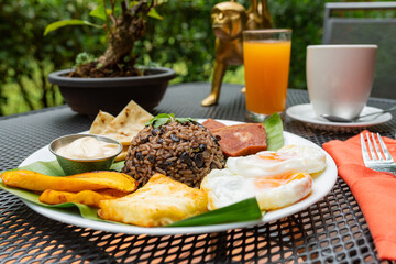 Gallo pinto breakfast served outdoors with eggs and plantains © STOCKEROcr