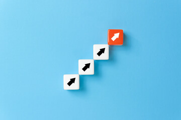 Ladder of success in business growth concept, Dice stacking as step stair with arrow up on blue background, copy space