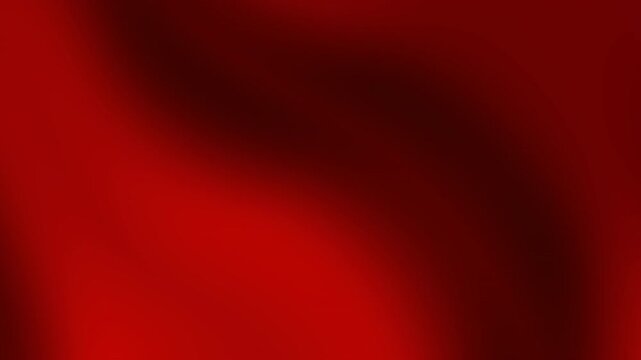 Flowing red fabric folds gently in dark environment close-up view