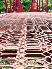 Red Metal Bridge with Steel Grating Floor Over River