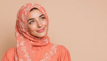 Young woman wearing a patterned head covering smiles while gazing upward toward empty space