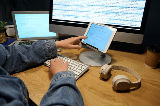Male programmer pointing at modern tablet computer in office, closeup