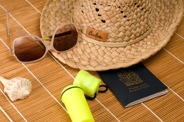 Cuban Hat, Sunglasses, Passport and Seashell on Bamboo Table Top