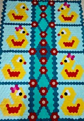 Obraz premium Handmade blanket made with hexagon patches with cute ducklings design