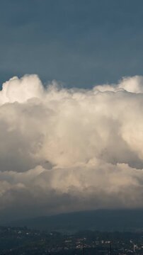 Vertical video - Timelapse of thick wall of clouds rolling in the afternoon sky