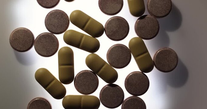 Drug pills spinning in a dark room