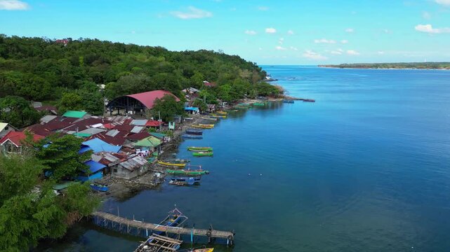Slow cinematic drone aerial over Luan Island, showcasing pristine beaches, turquoise waters, and lush tropical vegetation from above. Ideal for travel and landscape stock footage.