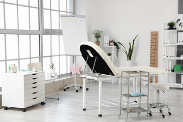 Interior of pediatrician's office with couch and plants