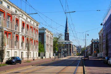 Street view of Parkstraat with tram tracks in front of the Sint-Jacobus de Meerdere church in The Hague (Den Haag), South Holland, The Netherlands
