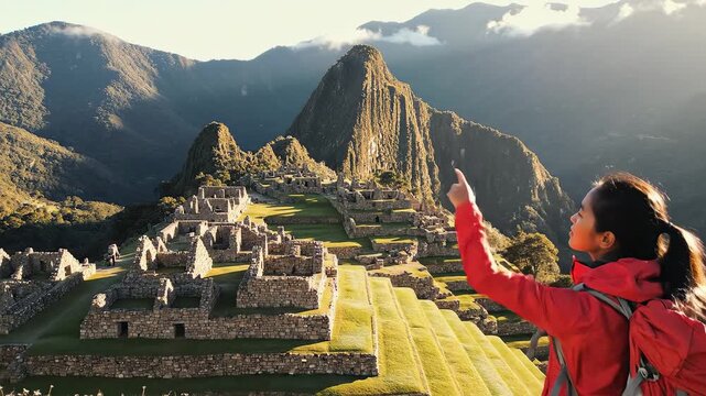 Hiker at ancient ruins in mountainous landscape