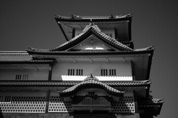 Fototapeta premium Japanese castle architecture with stone wall, black and white