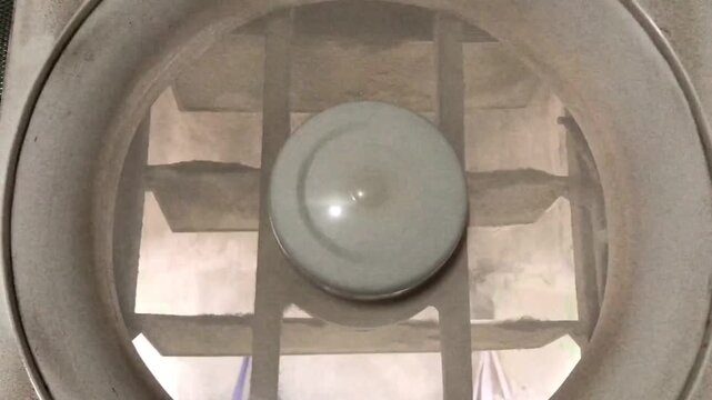 Close up view of the inside of a top loading washing machine drum.