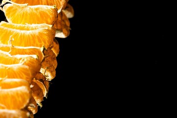 mandarin segments on dark background, juicy citrus