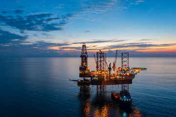 Aerial view of offshore jack up rig in a shipyard during sunset for oil and gas exploration and production. © bomboman