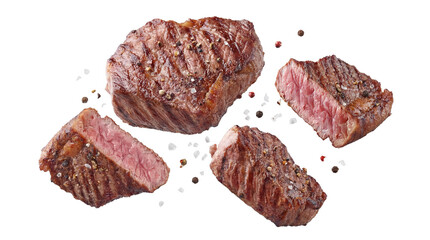 assorted grilled beef steaks with coarse salt and peppercorns, featuring different cuts and doneness levels, appetizing and flavorful meat, isolated on black