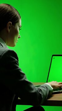 Green Screen over the shoulder shot of caucasian woman looking at chroma key office person using laptop computer with mockup scene 2 distortion, overlay, glitch, static noise, scan lines on black