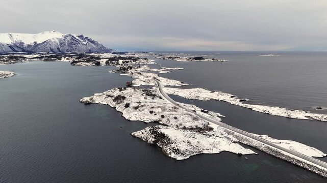 Aerial view of the snow covered landscape around the famous Atlantic Ocean Road connecting the municipalities Averoey and Hustad on the northwest coast of Norway.