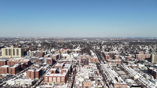 Queens new york expansive aerial view of the jamaica neighborhood in queens, new york city, with building rooftops and streets covered in snow on a sunny winter day, showing the urban landscape. Nyc