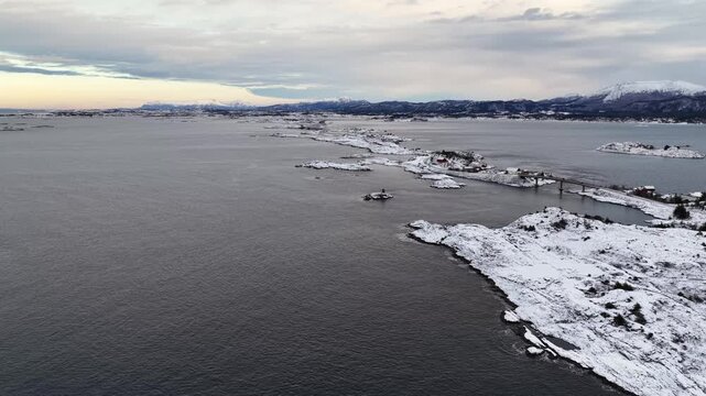 Aerial view of the snow covered landscape around the famous Atlantic Ocean Road connecting the municipalities Averoey and Hustad on the northwest coast of Norway.