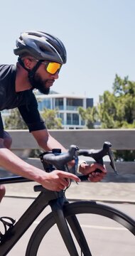 Exercise, man and cycling on bike in city for cardio workout, endurance challenge and pace training. Bridge, cyclist and riding bicycle in road for triathlon practice, sports performance and fitness