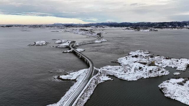Aerial view of the snow covered landscape around the famous Atlantic Ocean Road connecting the municipalities Averoey and Hustad on the northwest coast of Norway.