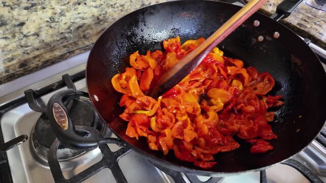 Colorful peppers frying in a pan, vibrant cooking scene in kitchen