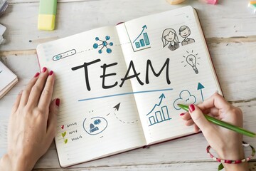 Creative brainstorming session with hands writing 'TEAM' in a notebook, featuring graphs and icons