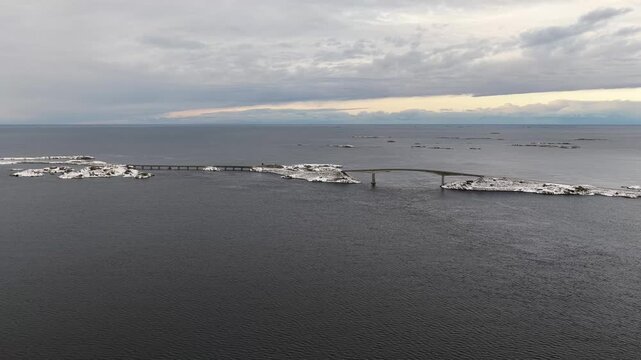 Aerial view of the snow covered landscape around the famous Atlantic Ocean Road connecting the municipalities Averoey and Hustad on the northwest coast of Norway.