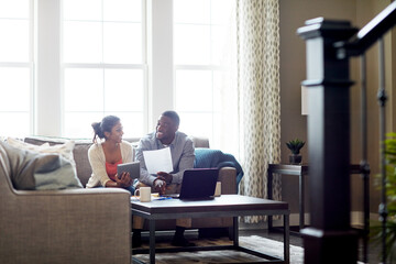 Obraz premium Smile, couple and tablet with document in home for finance report, mortgage and online payment. Happy, people and tech with financial paperwork, review budget and bank statement on household expenses