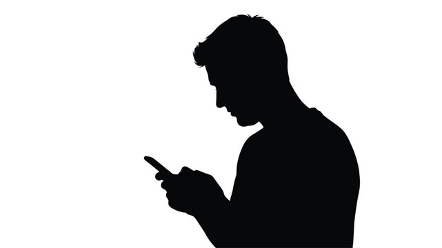 Silhouetted man looking down at a mobile phone in his hands