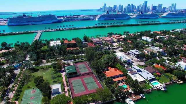 Aerial view of MacArthur Causeways spanning Biscayne Bay with Miami skyline and turquoise waters in Florida