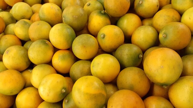 Fresh orange fruit background. Kimkit oranges in market basket. Also known as Triphasia trifolia, Kingkit, jeruk ranti, limau kiah, lime berry, limoncitong kastila.