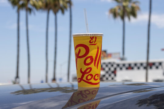 San Diego, CA, USA - May 14, 2022: Closeup of an El Pollo Loco branded soda cup left on top of a car. El Pollo Loco is an American fast food chain that specialize in Mexican-style grilled chicken.