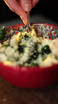 Chef preparing spinach and cheese filling for baking pie