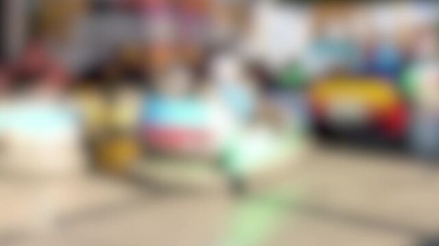 Blurred Motion of Colorful Bumper Cars at a Busy Funfair