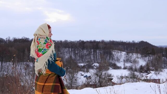 Joyful young woman during a winter walk in nature. Snow, activity, sincere emotions and seasonal mood.