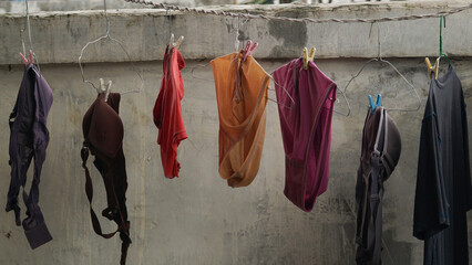 women's underwear drying on a hanger that is still wet